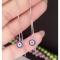گوشواره نقره بخیه طرح چشم نظر عیار 925 با روکش طلا سفید